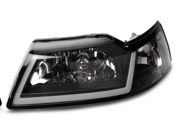 Raxiom 1999 - 2004 Ford Mustang Axial Series Headlights w/ LED Bar- Black Housing (Clear Lens)