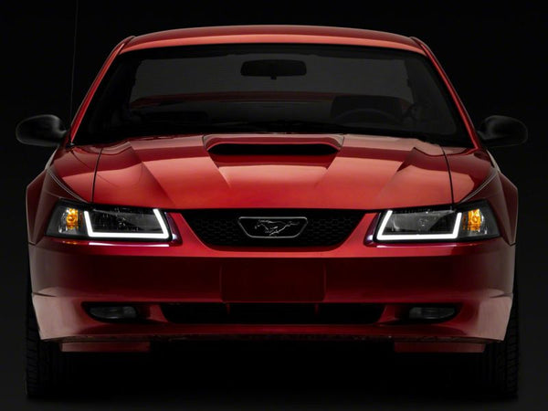 Raxiom 1999 - 2004 Ford Mustang Axial Series Headlights w/ LED Bar- Black Housing (Clear Lens)