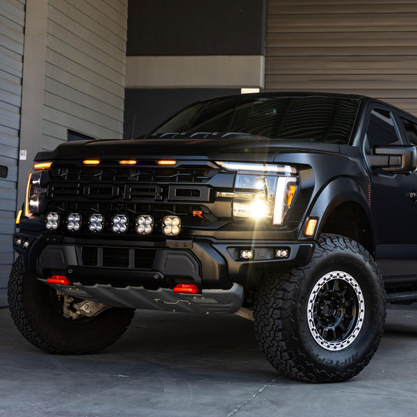 Black pickup truck with detailed front view in a garage setting
