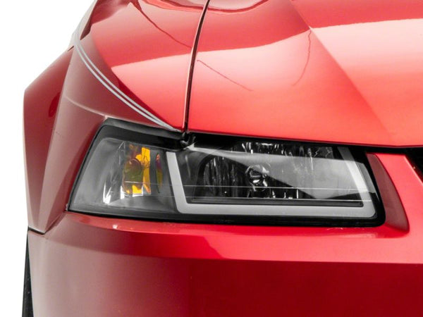 Raxiom 1999 - 2004 Ford Mustang Axial Series Headlights w/ LED Bar- Black Housing (Clear Lens)